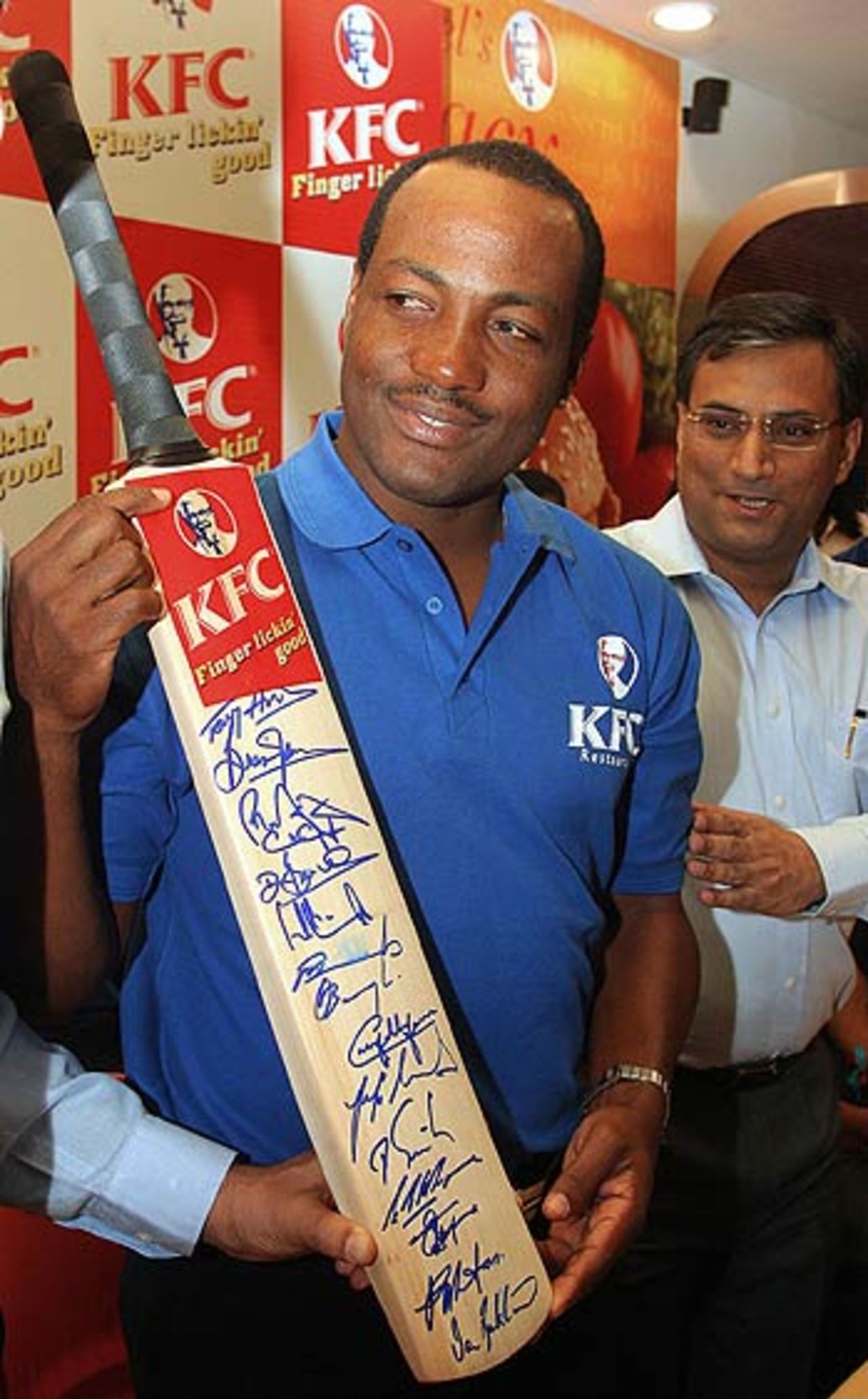 Brian Lara displays an autographed bat by all West Indies players in a promotional event, New Delhi, October 3, 2006