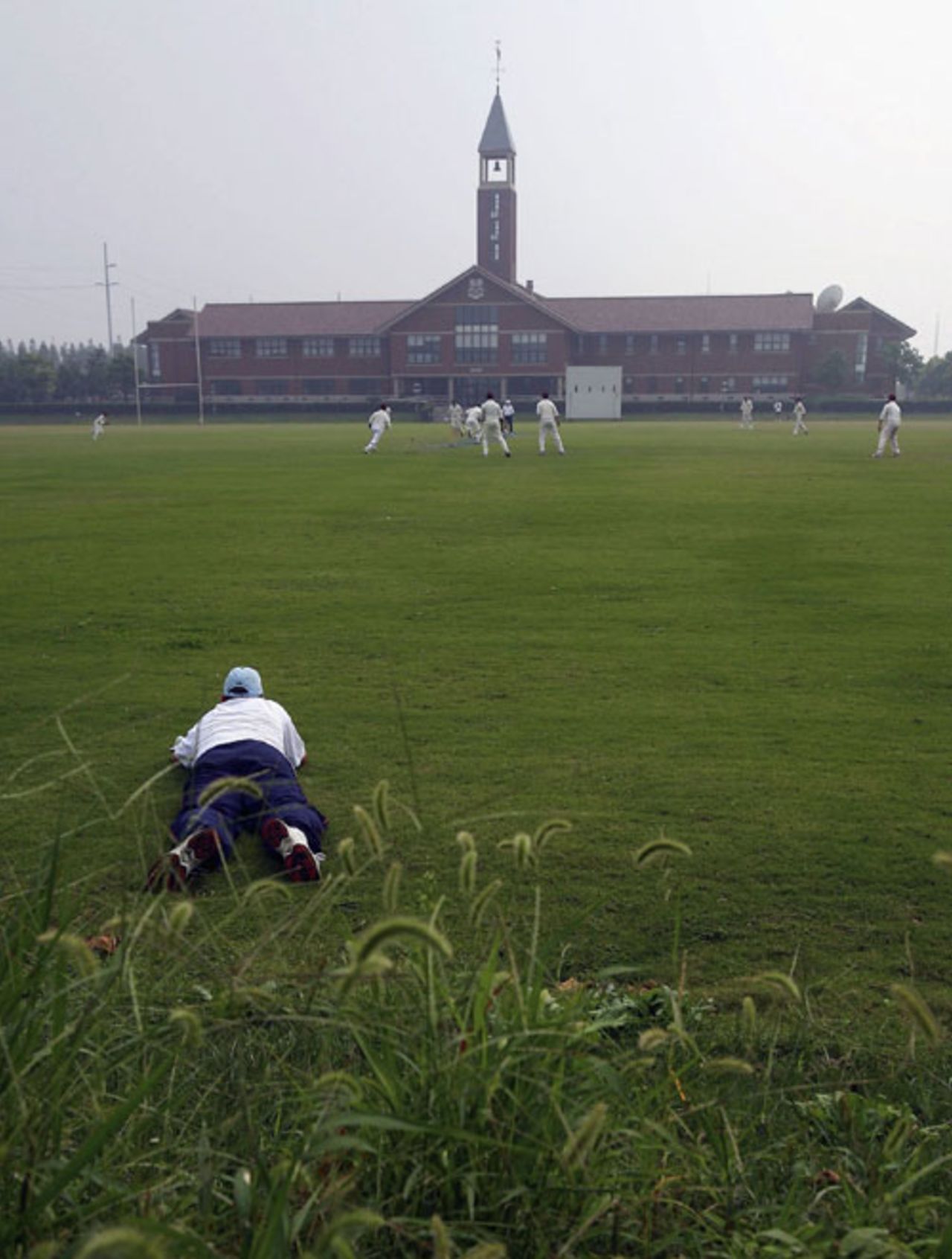 An MCC cricketer watches the one-day match against Shanghai Cricket Club, Shanghai, October 5, 2006 