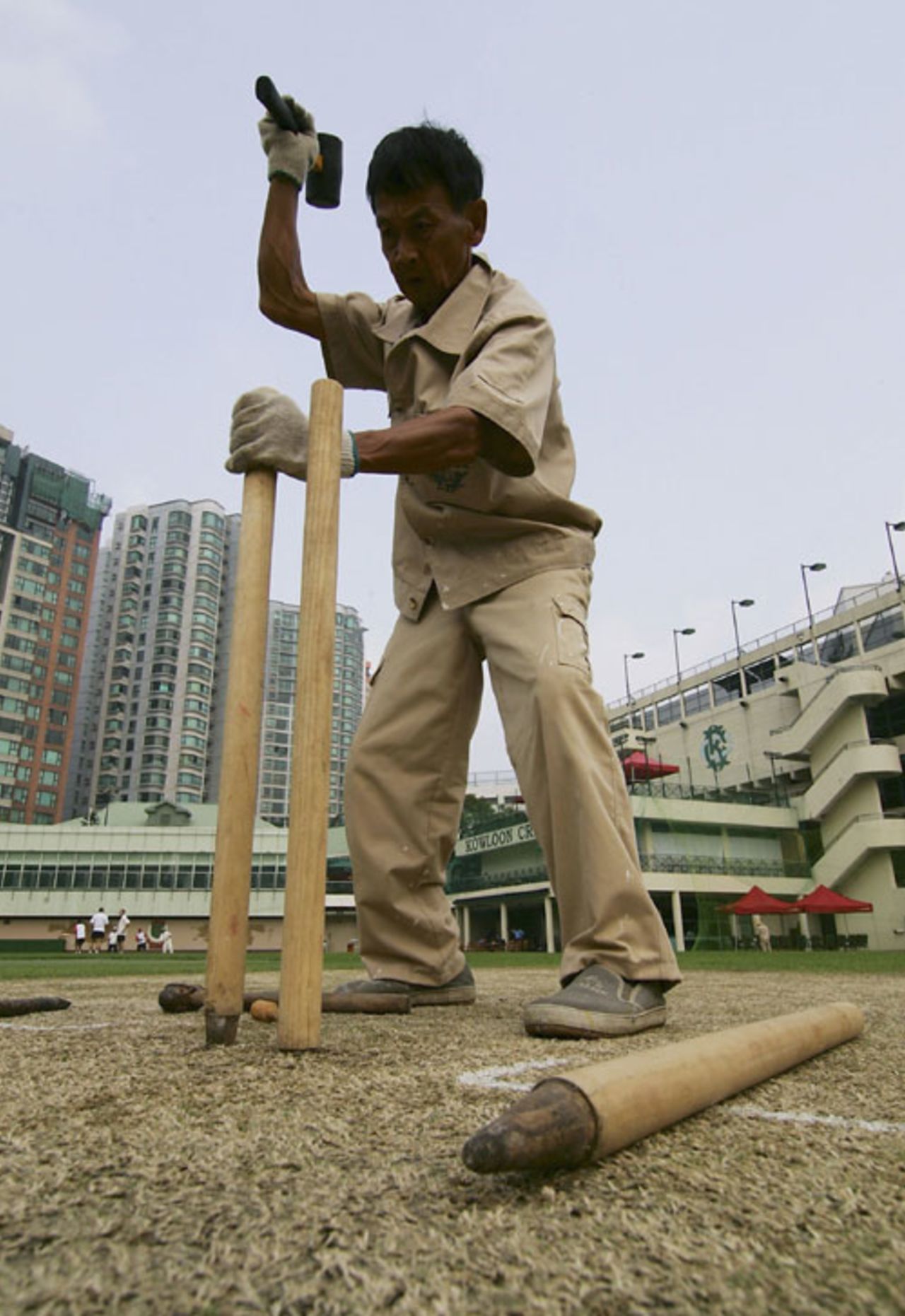A groundsman hammers in stumps ahead of  a match between MCC and Hong Kong Cricket Association,  Kowloon Cricket Club, Hong Kong, October 8, 2006