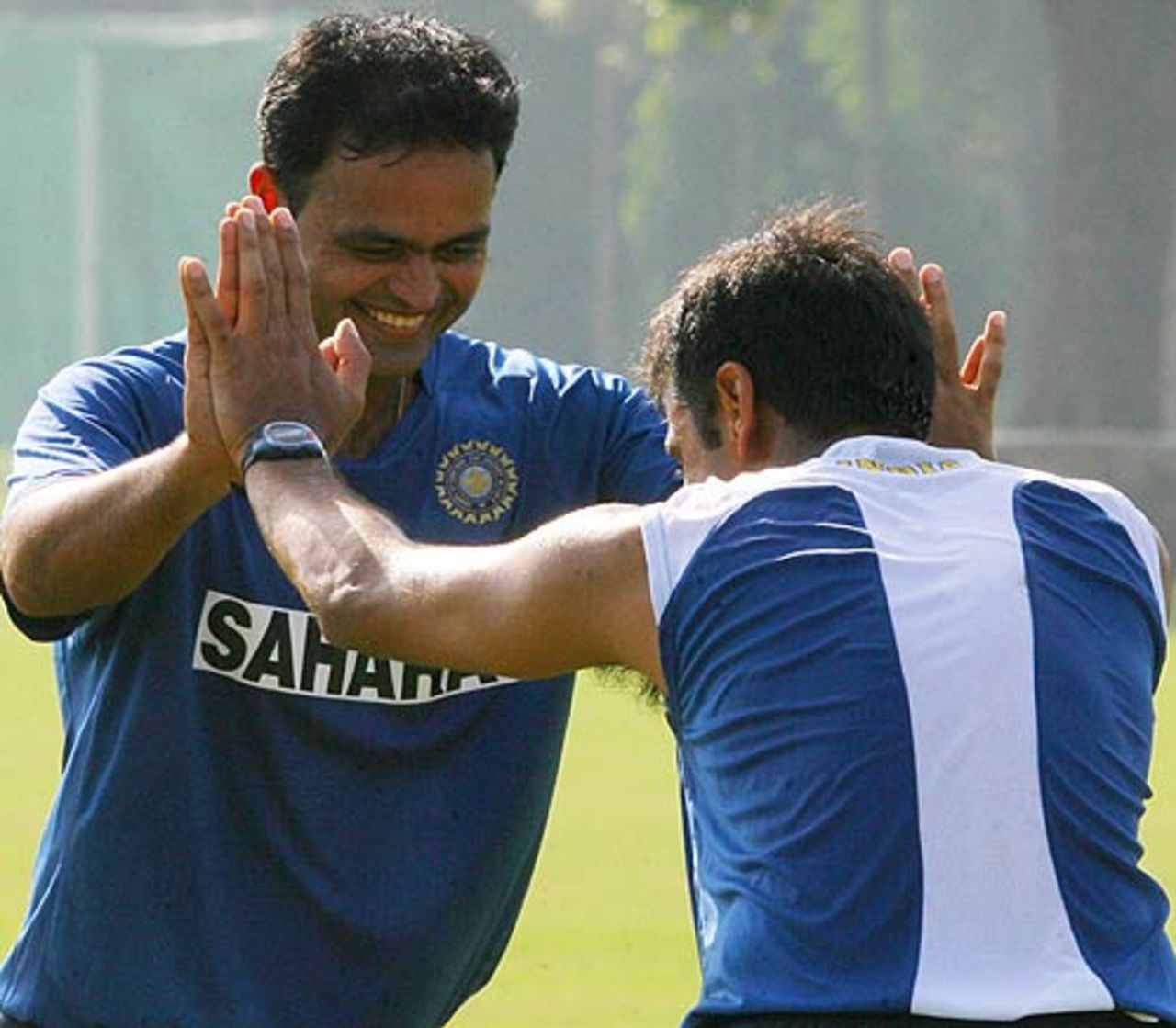 Dinesh Mongia and Rahul Dravid do some stretches at India's practice session, in New Delhi, October 10, 2006