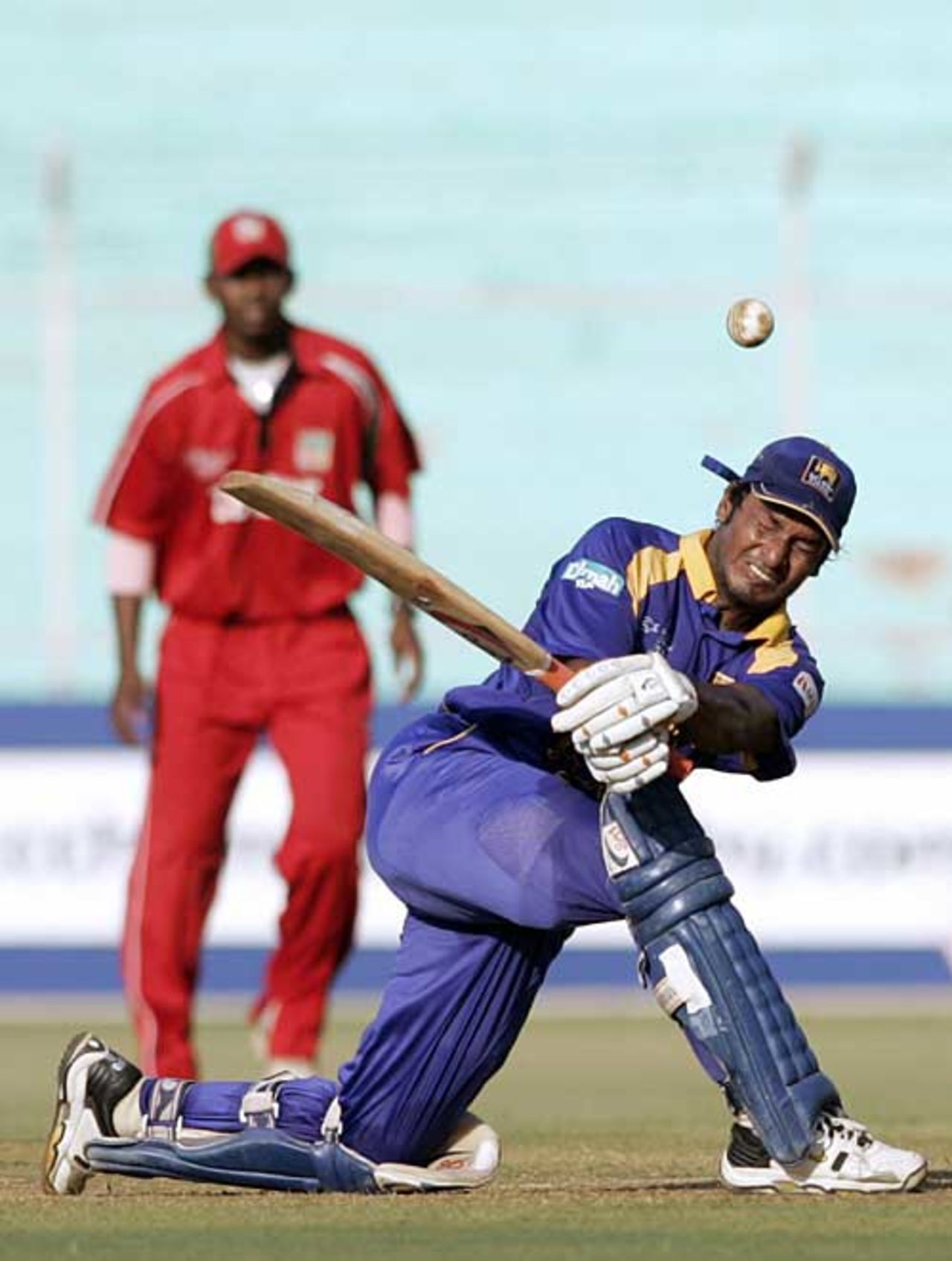 Kumar Sangakkara launches into a sweep, Sri Lanka v Zimbabwe, Champions Trophy, Ahmedabad, October 10, 2006