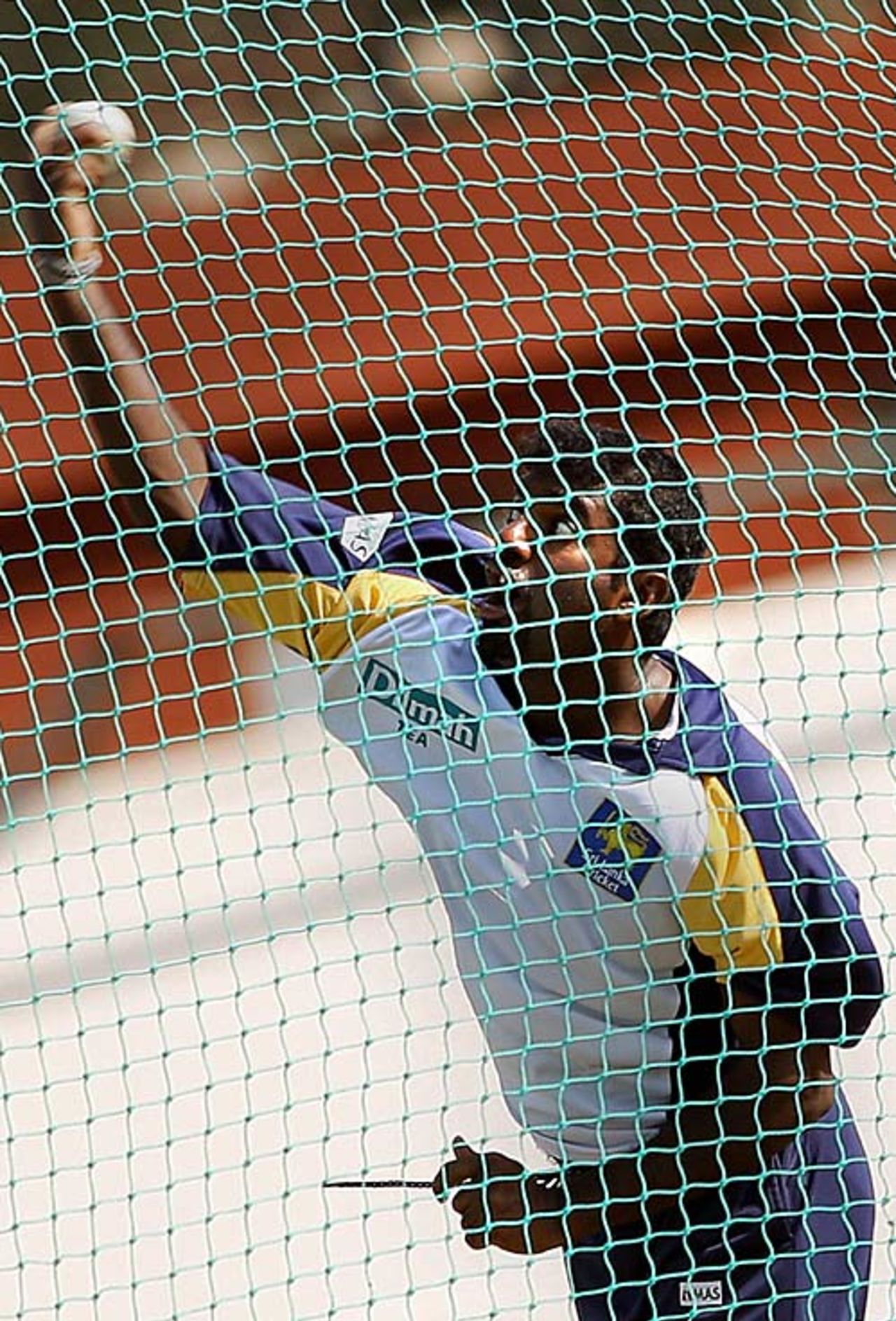Muttiah Muralitharan unfurls another delivery during a training session, Jaipur, October 16, 2006