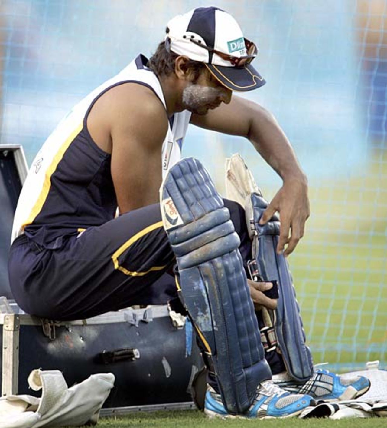 Kumar Sangakkara straps on his pads ahead of a net session, Mumbai, October 19, 2006