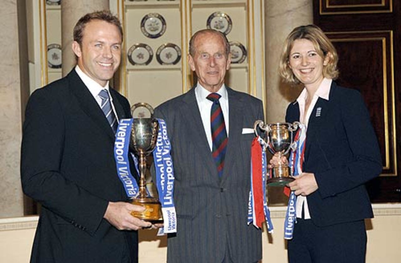 Sussex's captain, Chris Adams and the England Women's captain, Charlotte Edwards, pose with the Duke of Edinburgh at Buckingham Palace, October 25, 2006