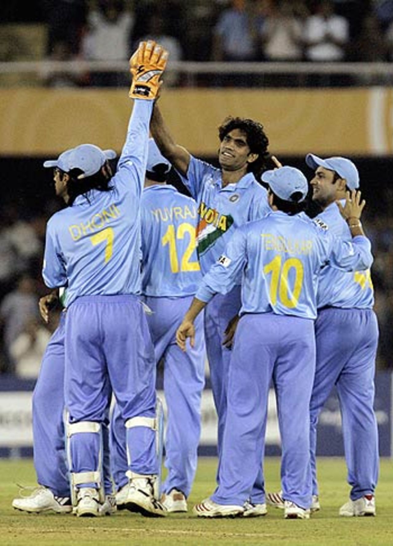 Munaf Patel and his team-mates celebrate after Chris Gayle falls to a skier, India v West Indies, 9th match, Champions Trophy, Ahmedabad, October 26, 2006