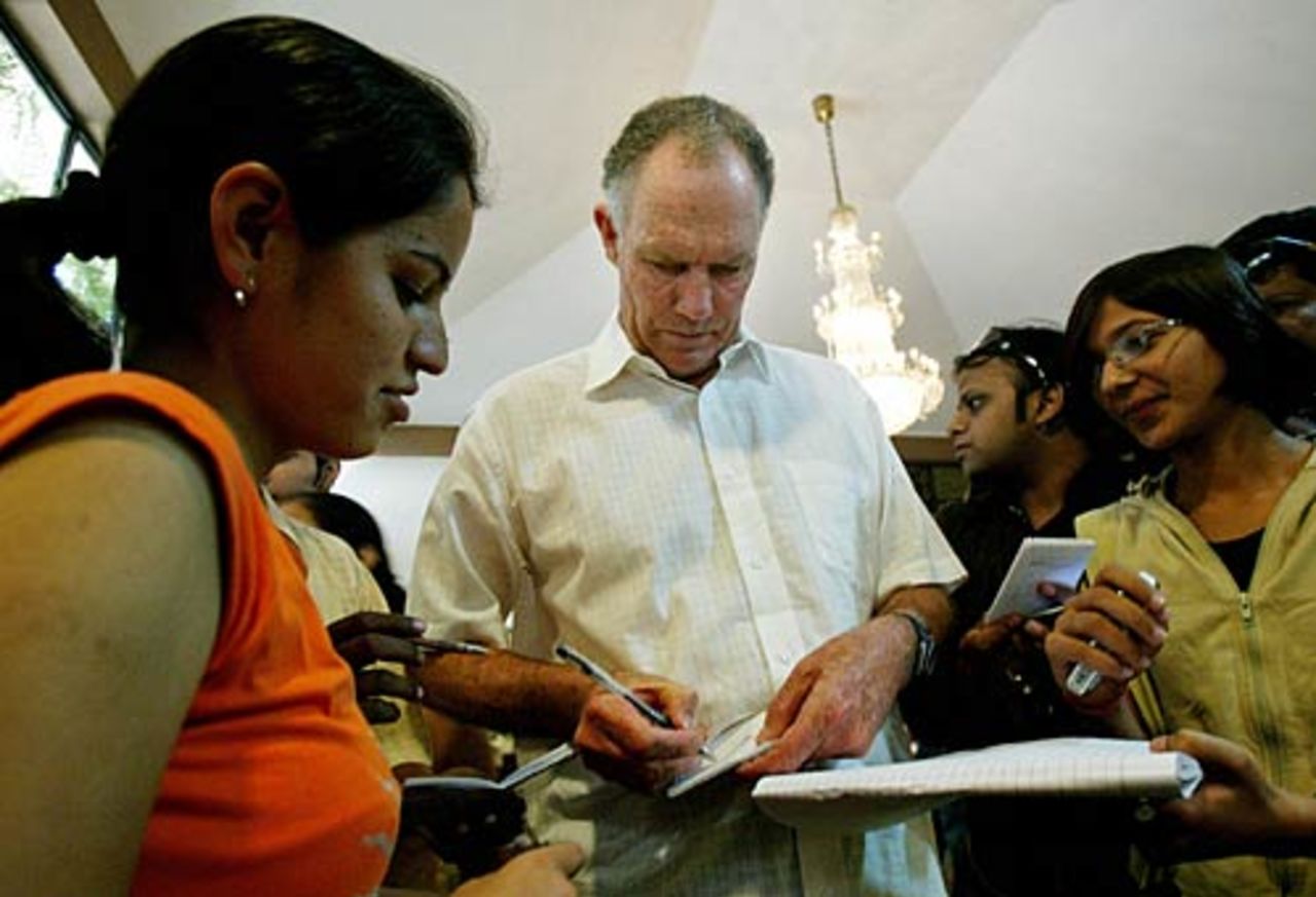 India cricket coach Greg Chappell signs autographs as he leaves the team hotel, Chandigarh, October 30, 2006