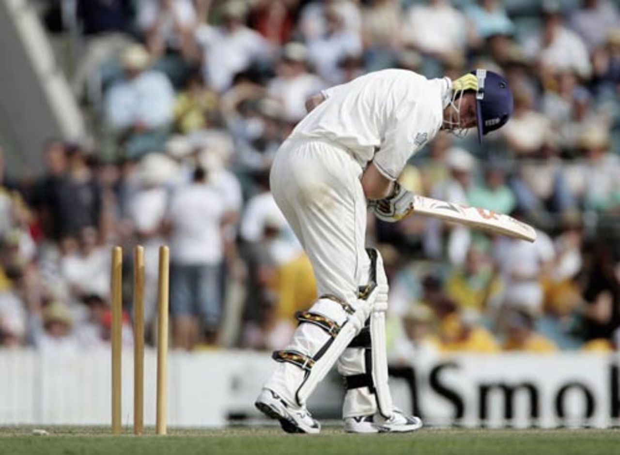 Andrew Flintoff looks back at his stumps after being bowled for one during the first Ashes tour match between the Australian Prime Minister's XI and England at Manuka Oval in Canberra, November 10, 2006