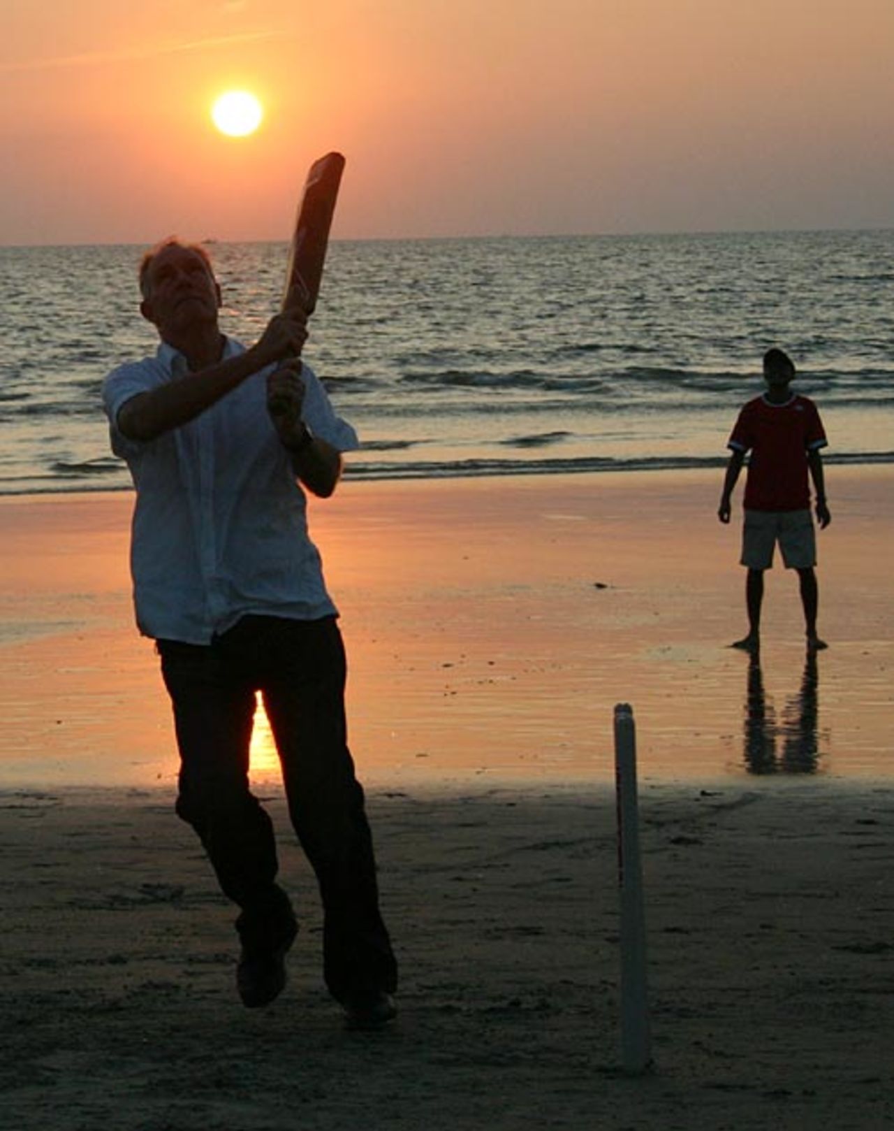 India's coach Greg Chappell plays beach cricket in Goa, November 9, 2006