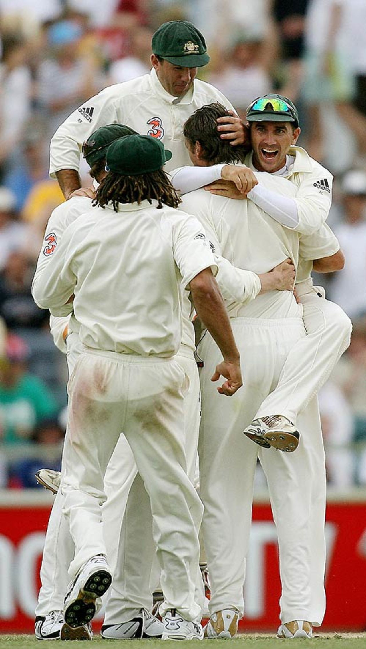 Glenn McGrath is mobbed by his team-mates after dismissing Matthew Hoggard, the second of his two wickets late in the day, Australia v England, 3rd Test, Perth, December 17, 2006