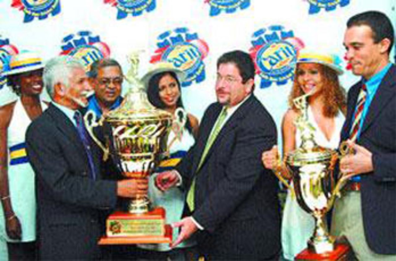 Trinidad and Tobago Cricket president and West Indies Cricket Board representative Deryck Murray, left, receives the Carib International Challenge Trophy from Carib CEO Andrew Sabga at the launch of the 2007 Carib Beer Series at Crowne Plaza, Trinidad, December 29, 2006 