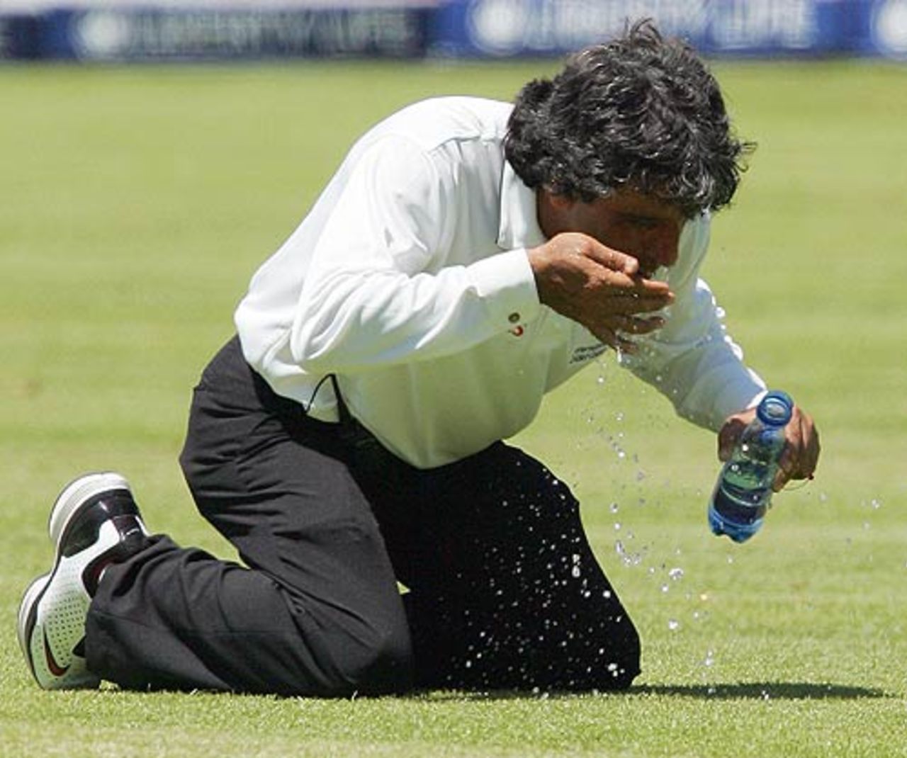 Umpire Asad Rauf washes something out of his eye, South Africa v India, 3rd Test, Cape Town, 1st day, January 2, 2007