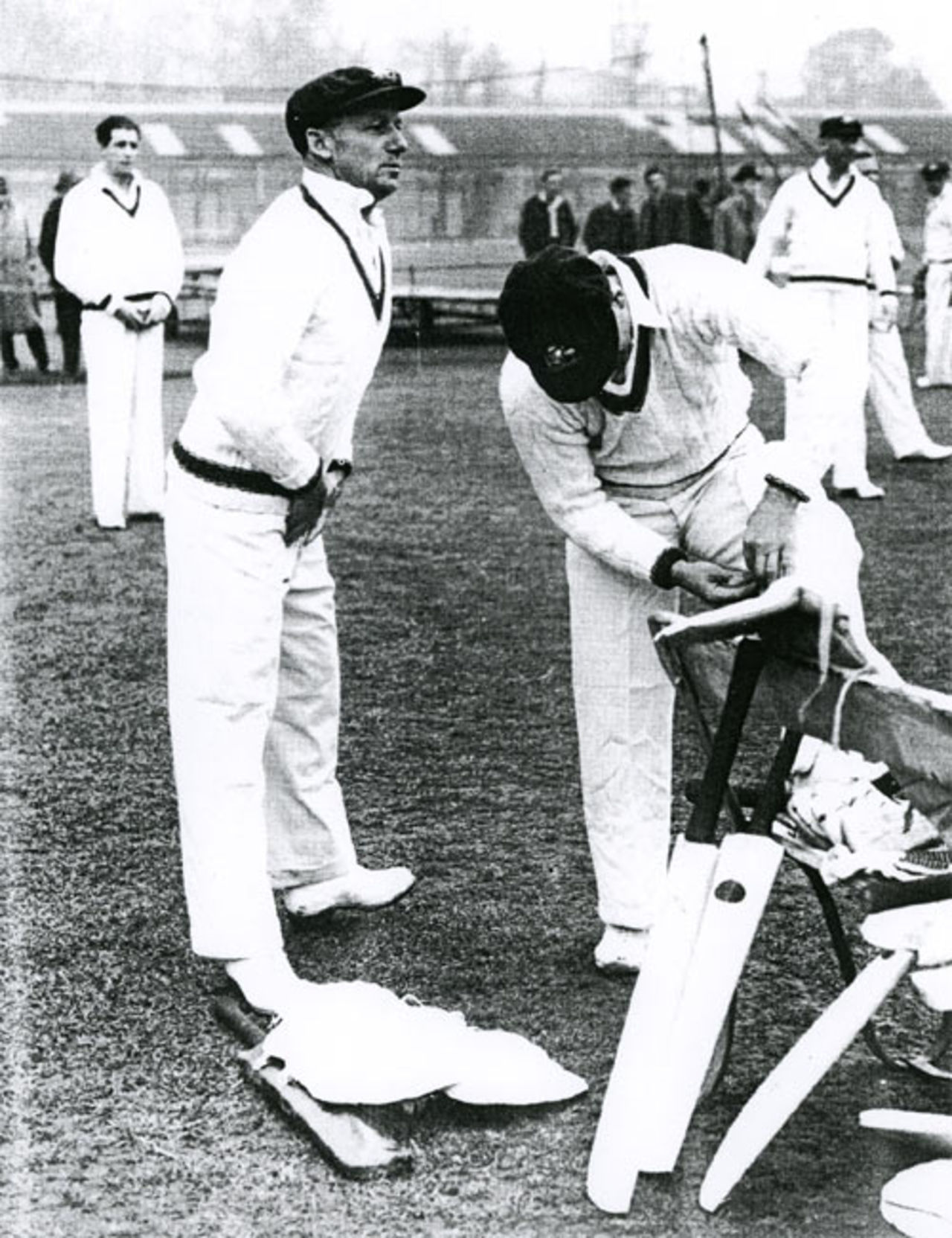 Don Bradman, 'box' in position, prepares to tune up in the nets at Lord's, 1948. Behind him, waiting to bowl, are Ernie Toshack (left) and Doug Ring, Lord's, May 1948