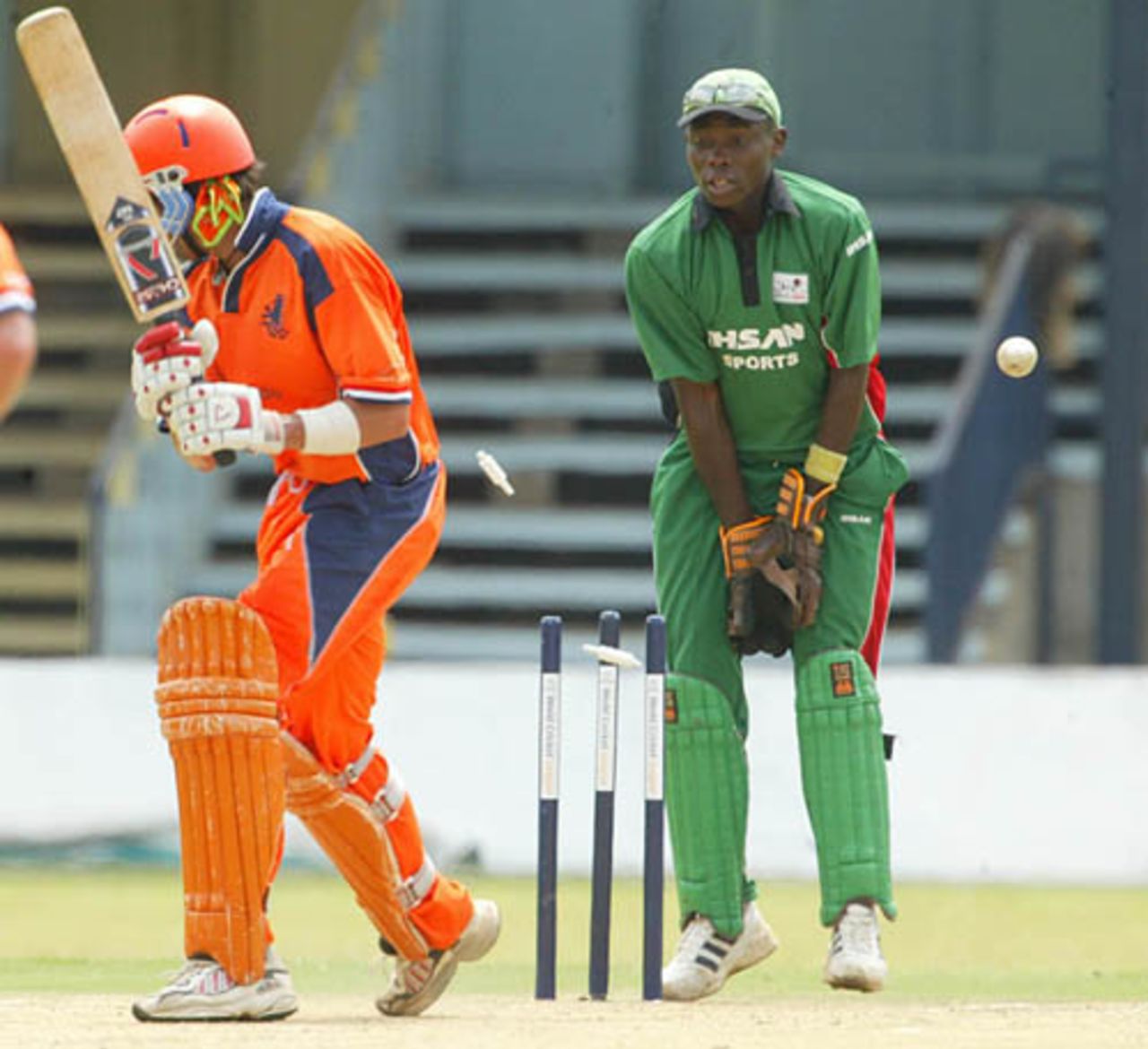 Netherlands batsman, Billy Stelling, is clean bowled as Kenyan wicketkeeper Maurice Ouma watches,  during the ICC World Cricket League Division 1 against Kenya at the Nairobi Gymkhana  Club in Nairobi, Wednesday, Jan. 31, 2007
