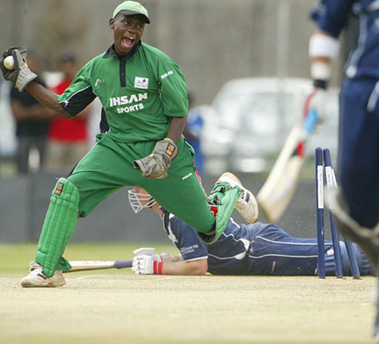 Maurice Ouma celebrates as Neil McCallum lies on the ground after being run out, Kenya v Scotland, World Cricket League, , February 4, 2007
