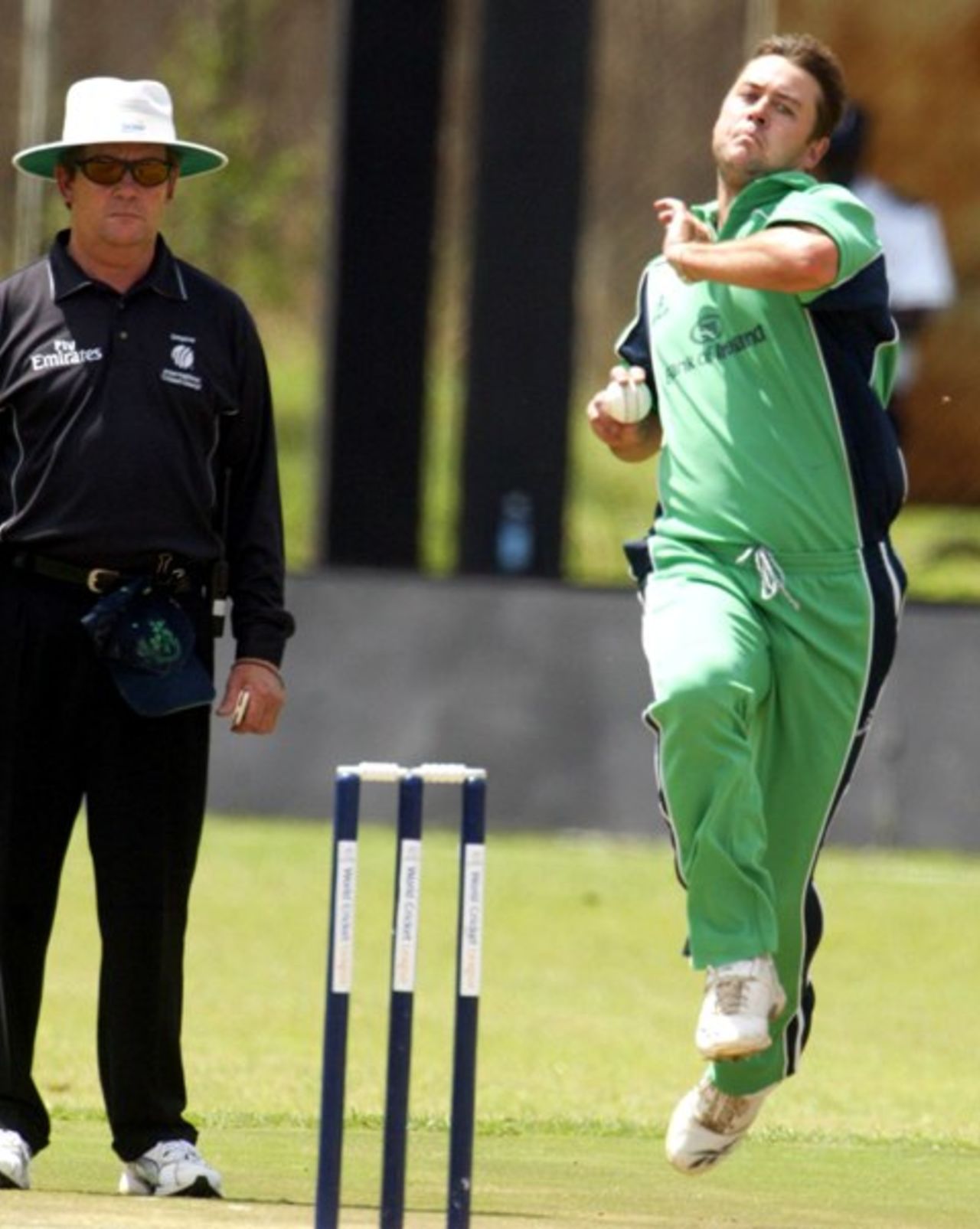 Ireland's fast bowler Dave Langford-Smith, in action as the New Zealand empire Gary Baxter, left, looks during the ICC World Cricket League Division 1 against Netherlands at the Nairobi Gymkhana  Club in Nairobi, Tuesday, Feb. 5, 2007