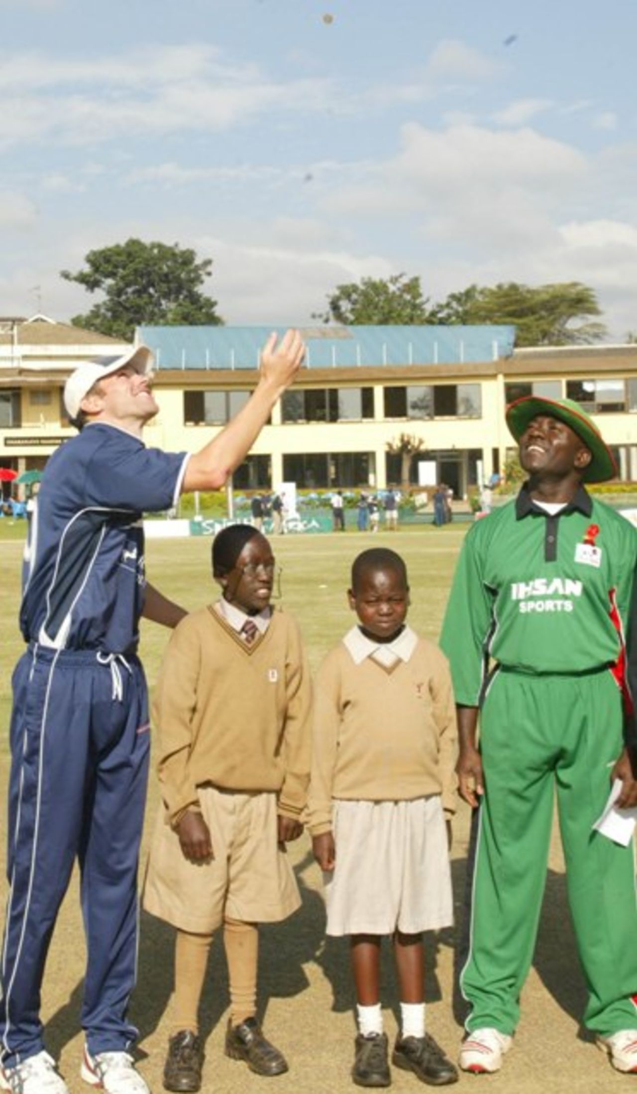 Scotlands captain Graig Wright, left, and Kenyan captain Steve Tikolo, third left, walk with HIV Aid chiuldrenKevin Wanjala, 15, second left, and Emma Otieno, 12, during the toss of Kenya and Scotland. On the right Roshan Mahanama, Game referee.