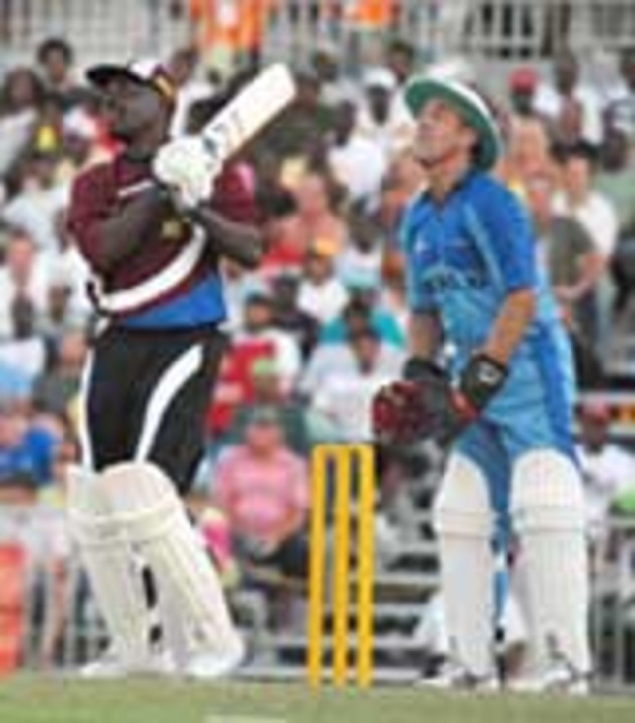 Collis King smashes a six as Alec Stewart watches on at the opening of the new Kensington Oval, West Indies All Stars v World XI, Barbados, February 17, 2007