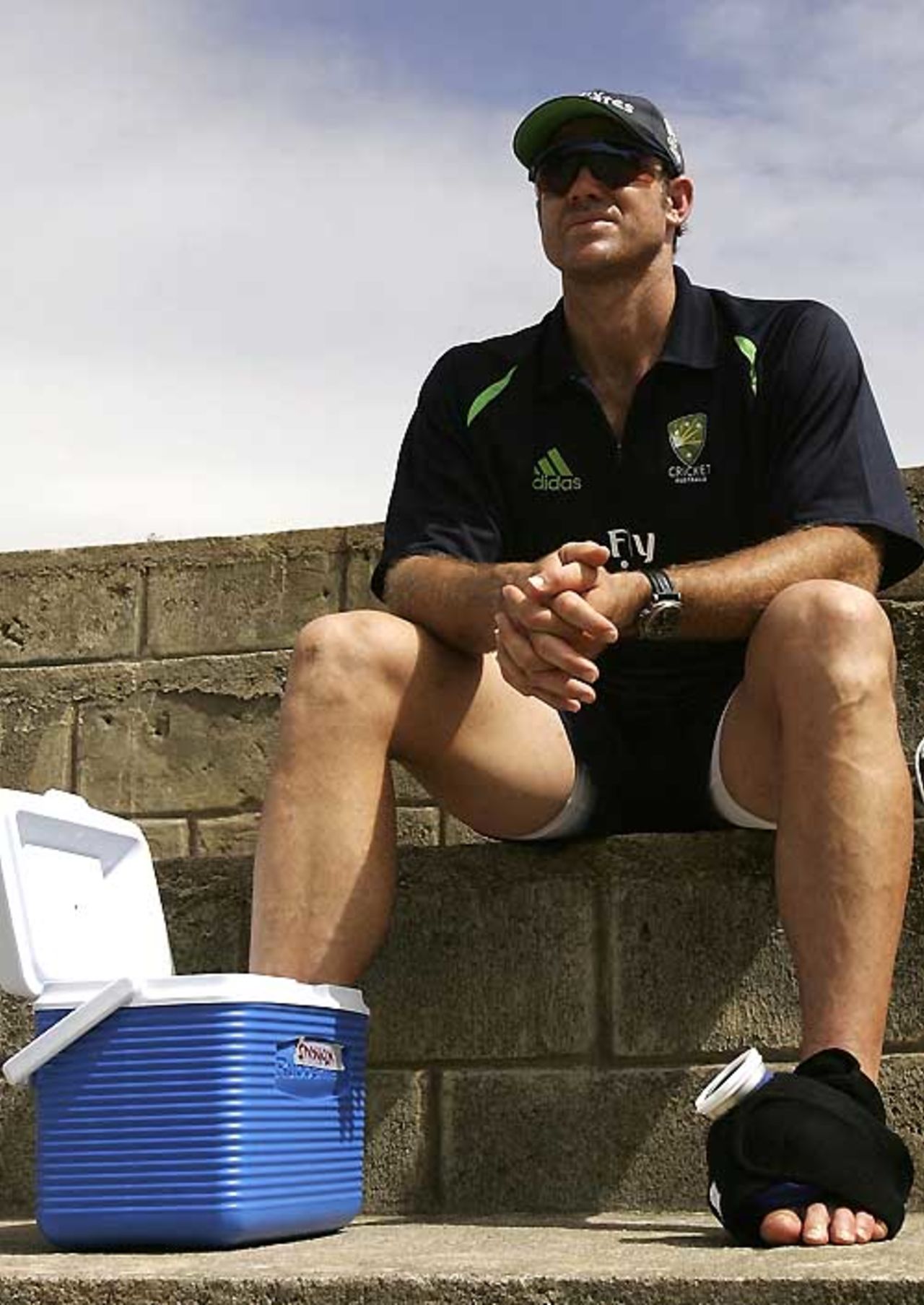 Matthew Hayden of Australia ices his broken toe while sitting on the steps during training at Stubbs Cricket Ground, St Vincent, March 4, 2007
