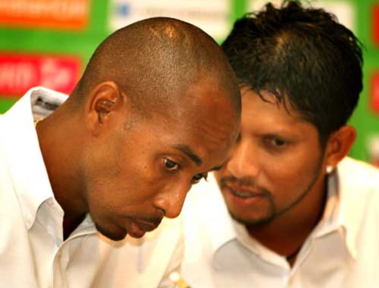 Ian Bradshaw listens to Ramnaresh Sarwan during a press conference,  in Montego Bay, March 5, 2007