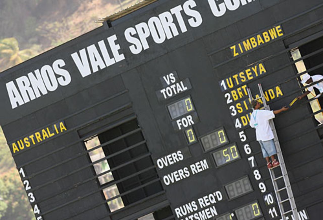A worker prepares the scoreboard for the warm-up game between Australia and Zimbabwe, Arnos Vale, March 6, 2007