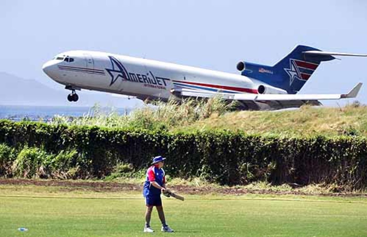 Duncan Fletcher, England's coach, hits a catch as a plane takes off not far away in the background, from the ET Joshua Airport, Sion Hill Ground, Kingstown, St Vincent, March 6, 2007