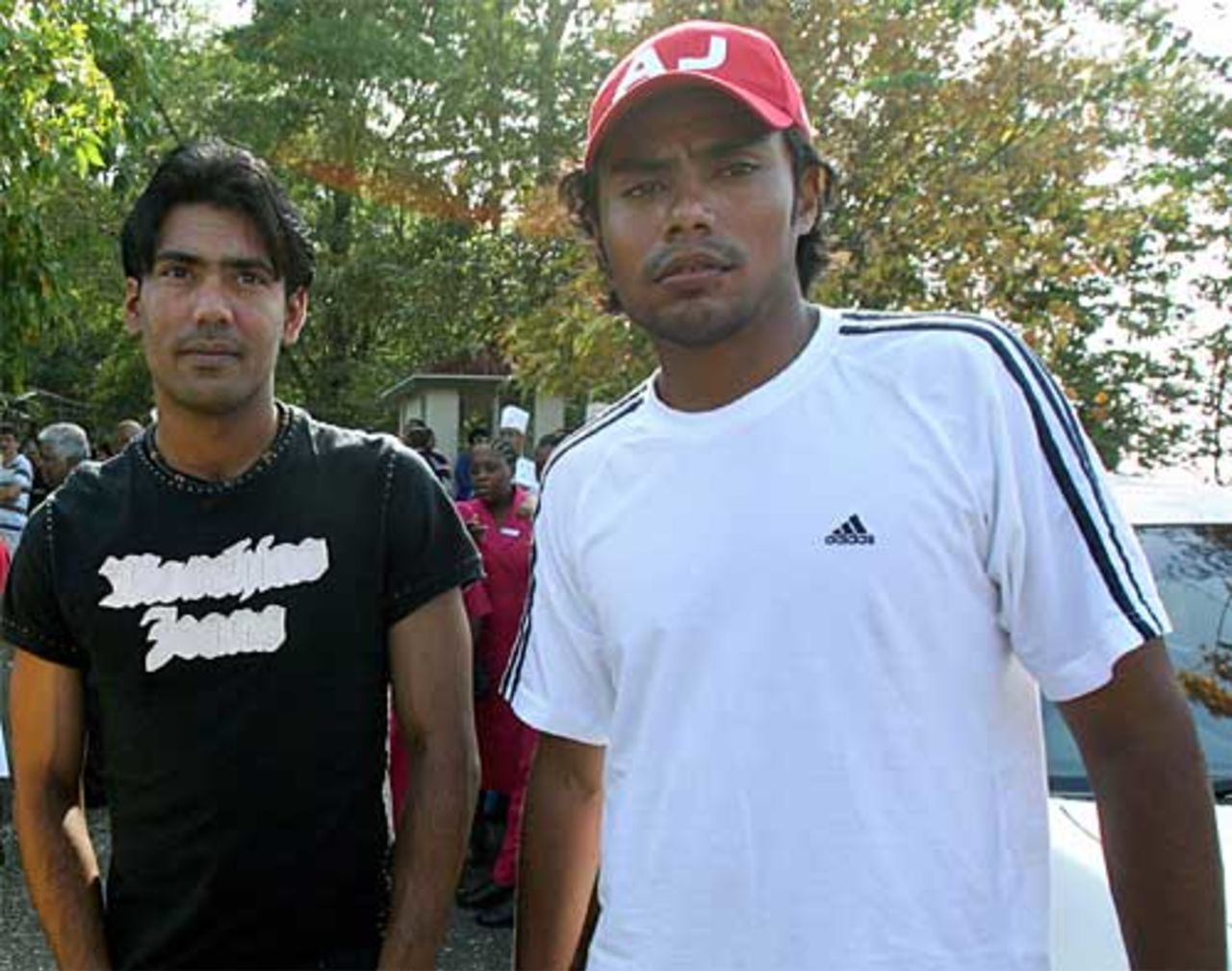 Mohammad Sami and Danish Kaneria wait patiently after smoke at their hotel caused an evacuation, Port of Spain, 7 March 2007