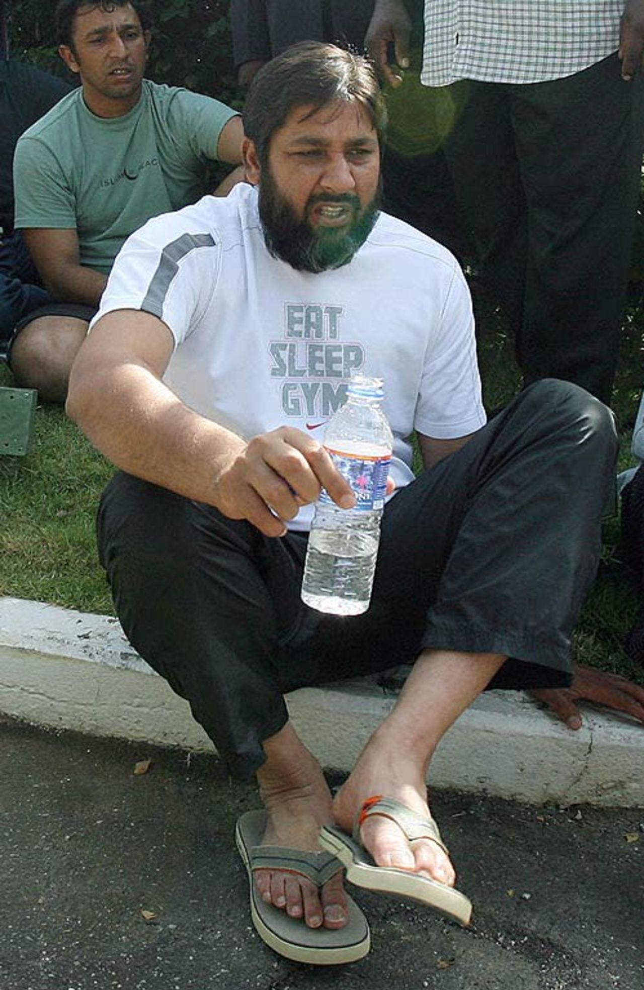 Inzamam-ul-Haq sits on the kerb during a fire alarm at the team hotel, March 7, 2007