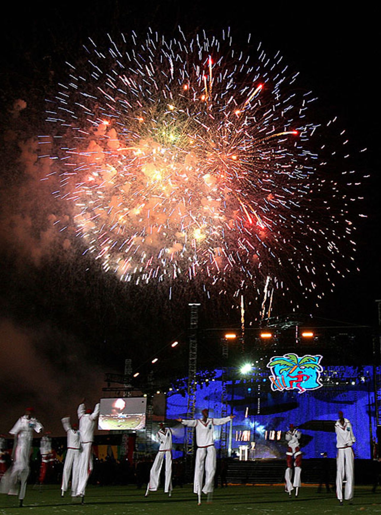 Performers dance as fireworks illuminate the night sky during the opening ceremony of the 2007 World Cup, Trelawny, March 11, 2007