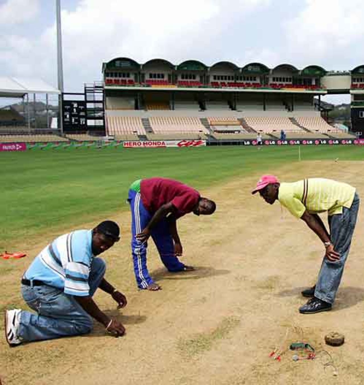 Groundstaff prepare the pitch for at the Beausejour Stadium, 2007 World Cup, St Lucia, March 12, 2007