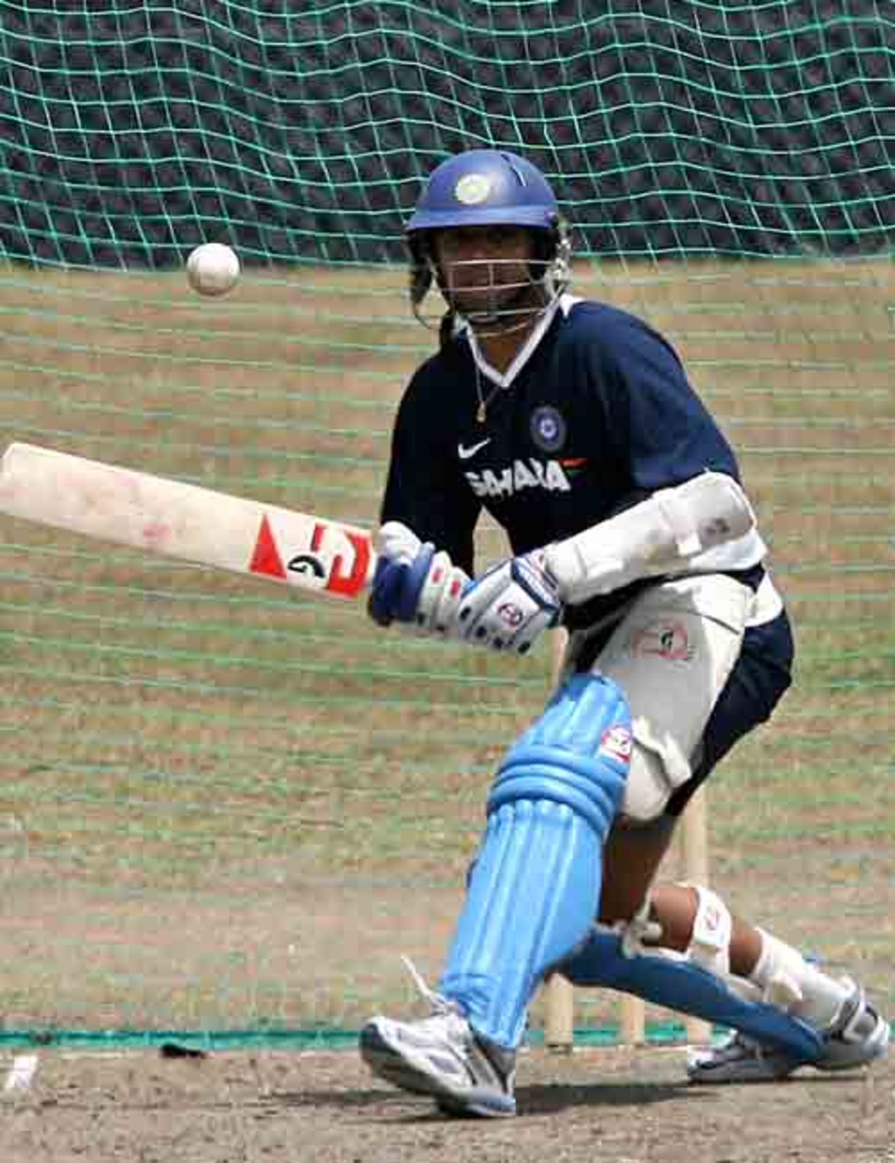 Rahul Dravid lines up for a paddle sweep during India's net session at Couva, Trinidad, March 14, 2007