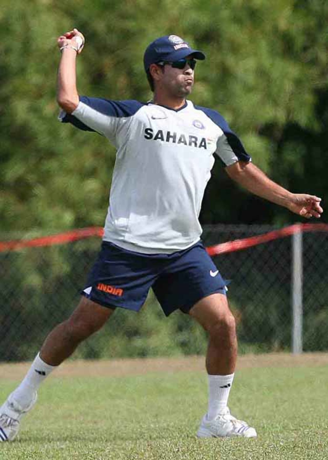 Sachin Tendulkar attempts a direct hit during India's warm-up session at Couva, Trinidad, March 14, 2007