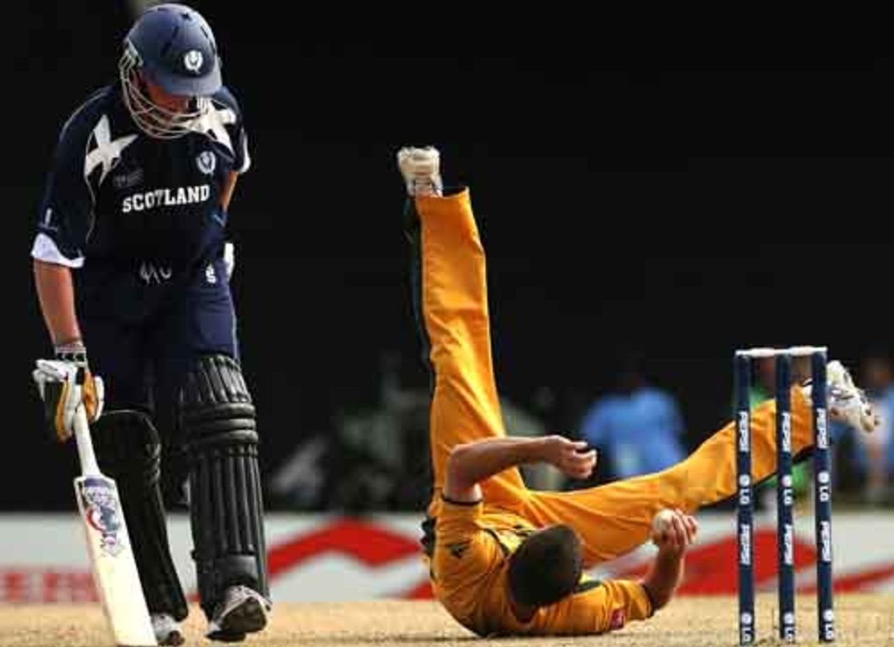 Brad Hogg does a tumble while fielding off his own bowling while Dougie Brown looks on, Australia v Scotland, Group A, St Kitts, March 14, 2007