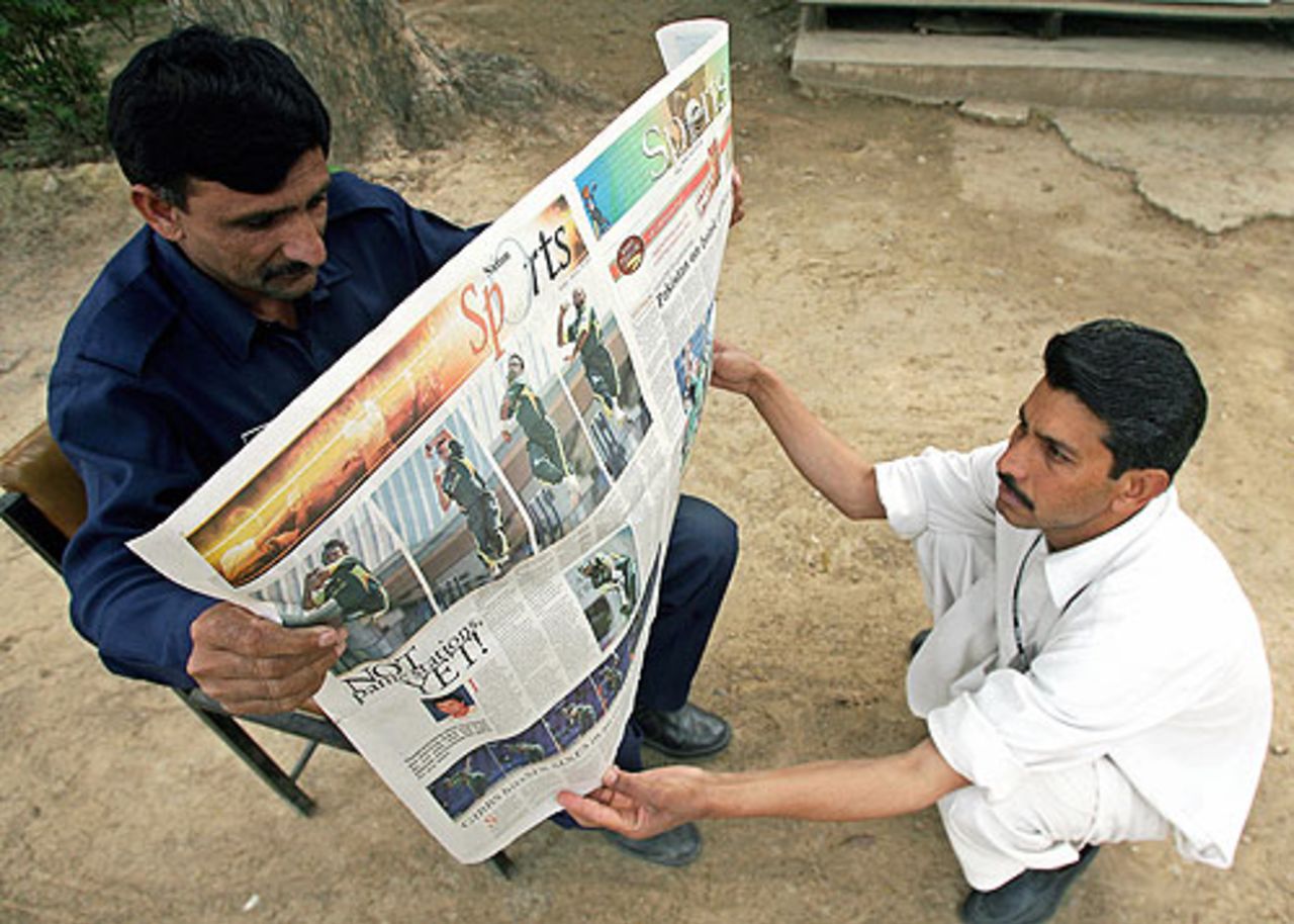 Pakistan cricket fans wake up to read the news of Pakistan's elimination, Islamabad, March 18, 2007