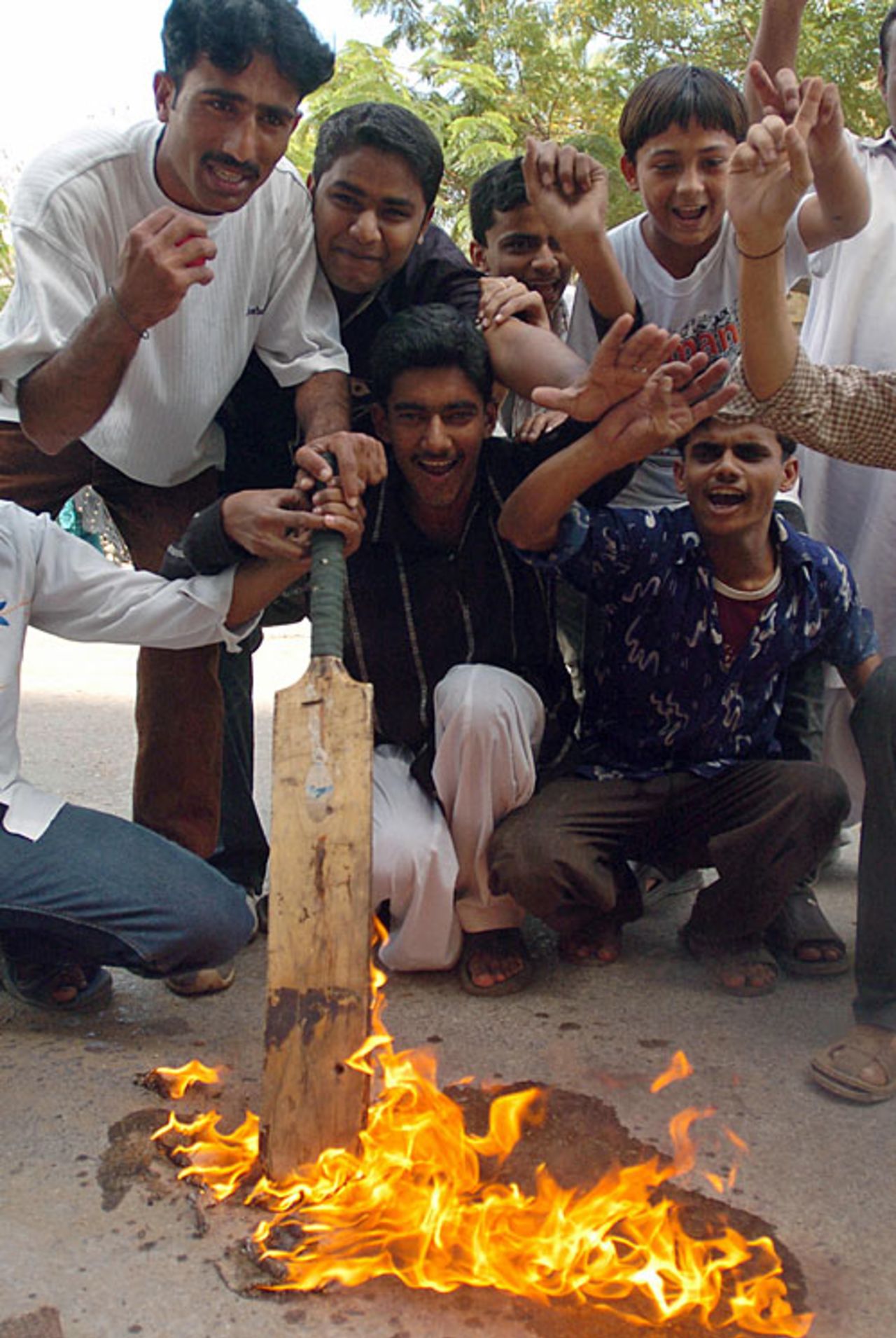 Pakistan cricket fans burn a bat in protest at their side's dismal World Cup performance, Karachi, March 18, 2007