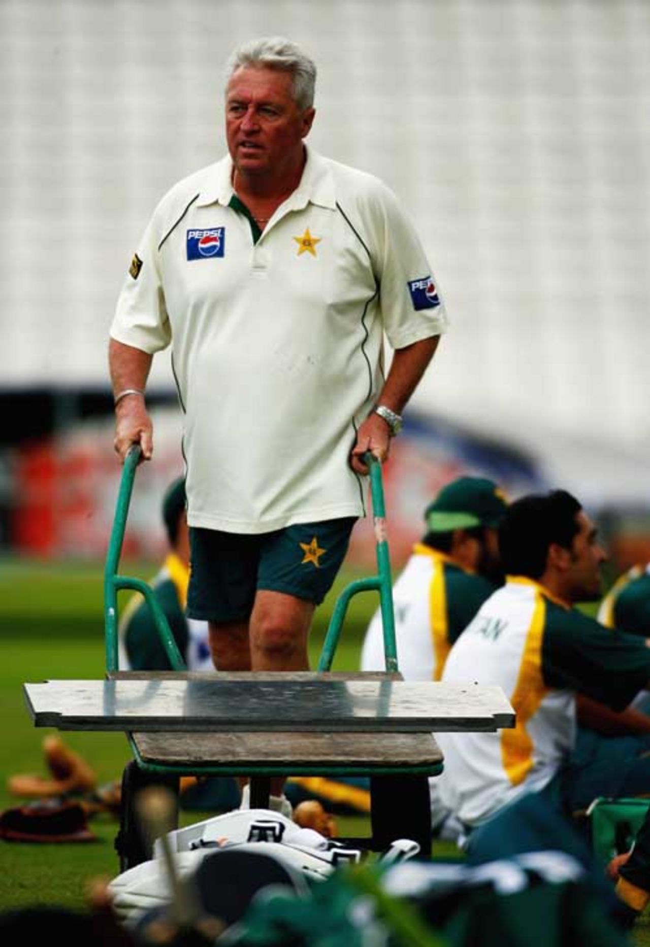 Bob Woolmer wheels  a slab of marble during a training sesson in England, August 2006