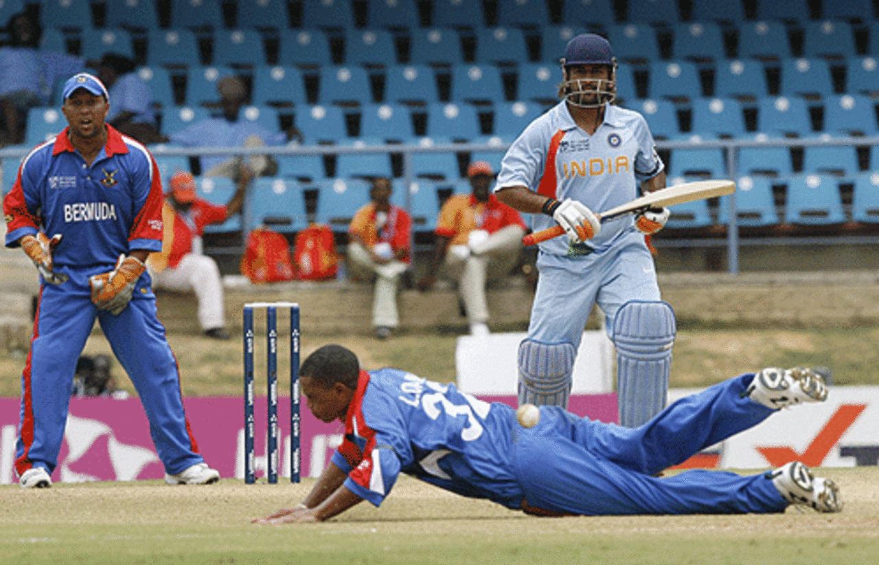 Bermuda bowler Lionel Cann tries to stop a shot off Mahendra Singh Dhoni, Bermuda v India, Group B, Trinidad, March 13, 2007