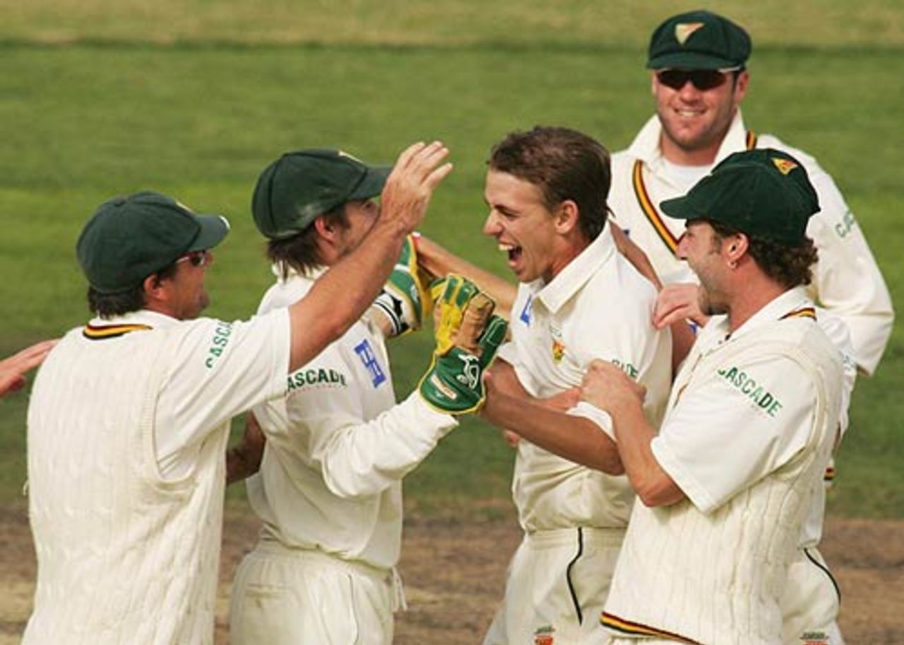 Luke Butterworth's team-mates congratulate him on a wicket, Tasmania v New South Wales, Pura Cup final, Hobart, March 20, 2007