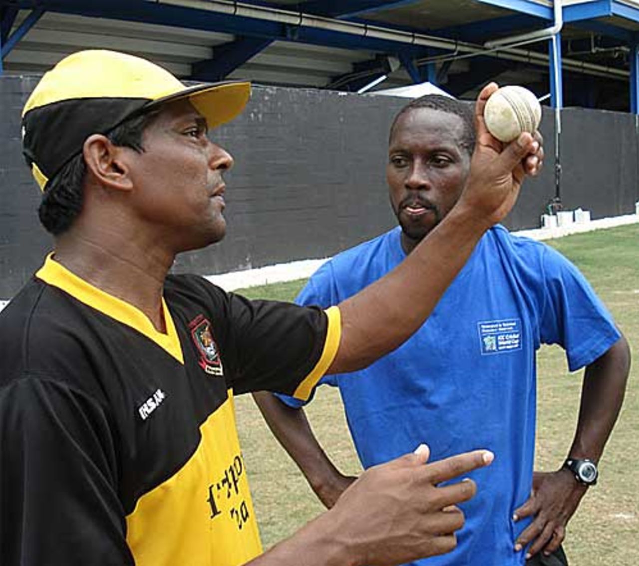 Mohammad Rafique shows a local left-arm spinner the tricks of an arm-ball, Trinidad, March 20, 2007