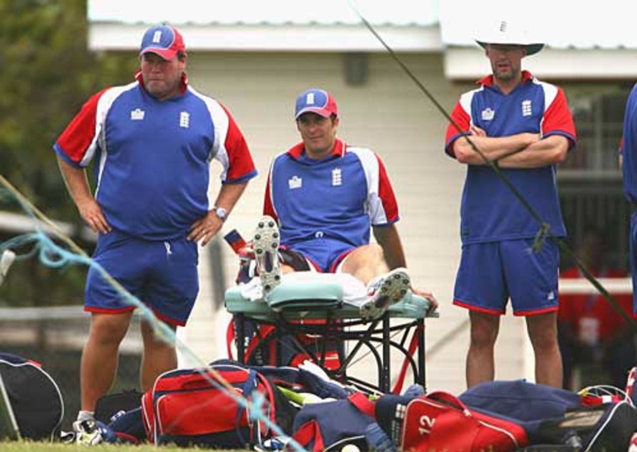 Michael Vaughan gets treatment on his knee from Dean Conway (left) after tripping on a pot hole, St Lucia, March 20, 2007