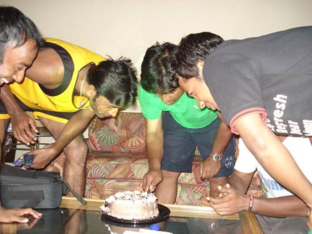 A few Bangladesh cricketers take turns in cutting Tamim Iqbal's birthday cake, Trinidad, March 20, 2007