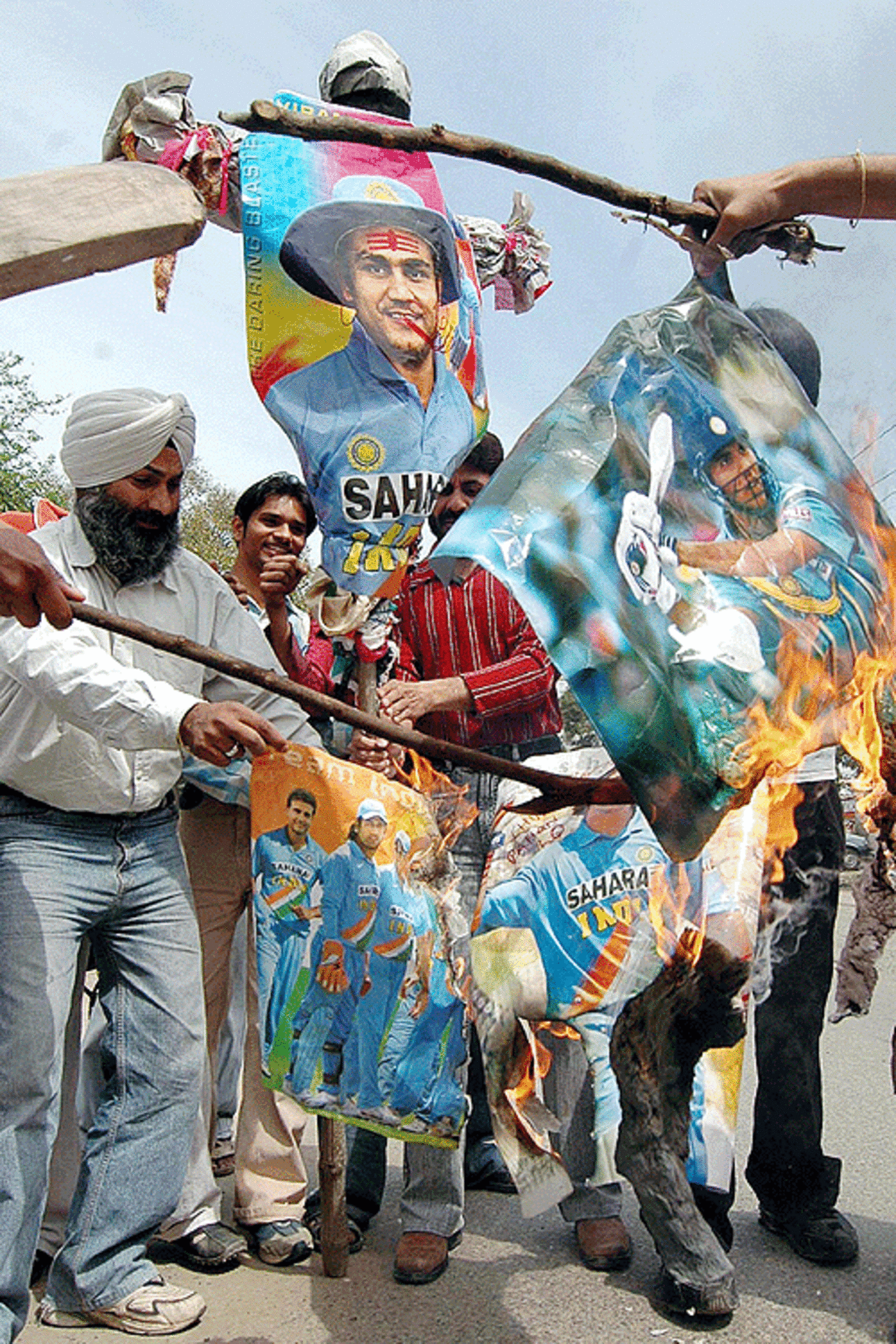 Protestors burn posters of Indian players after the team's defeat against Sri Lanka, Amritsar, India, March 24, 2007