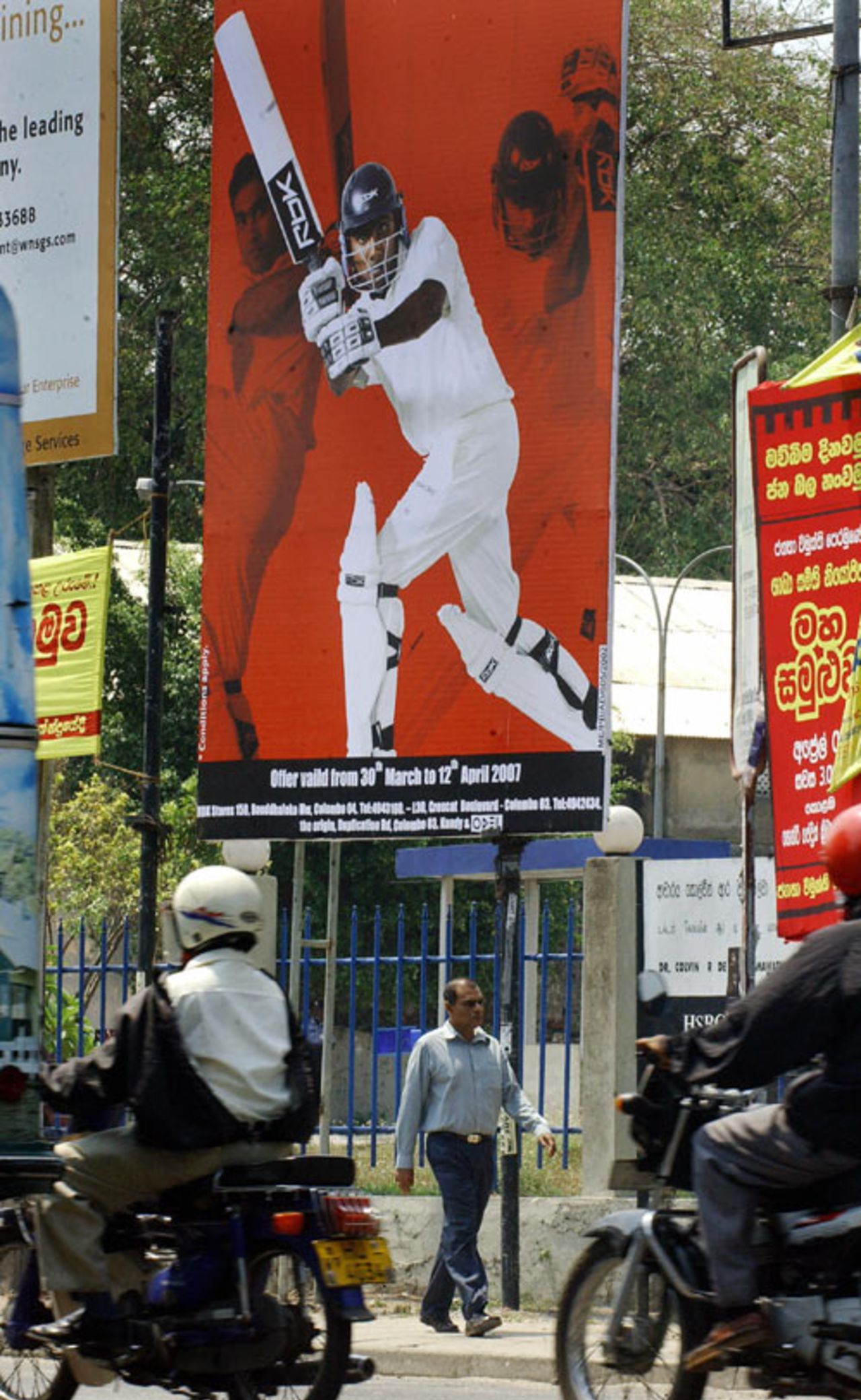 A man walks past a billboard depicting Sri Lanka's captain Mahela Jayawardene, Colombo, March 28, 2007