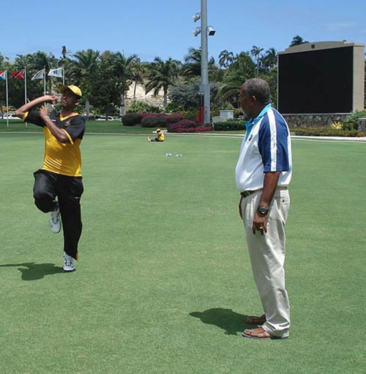 Andy Roberts helps Shahadat Hossain with his action at the Stanford Cricket Ground, Antigua, March 28, 2007