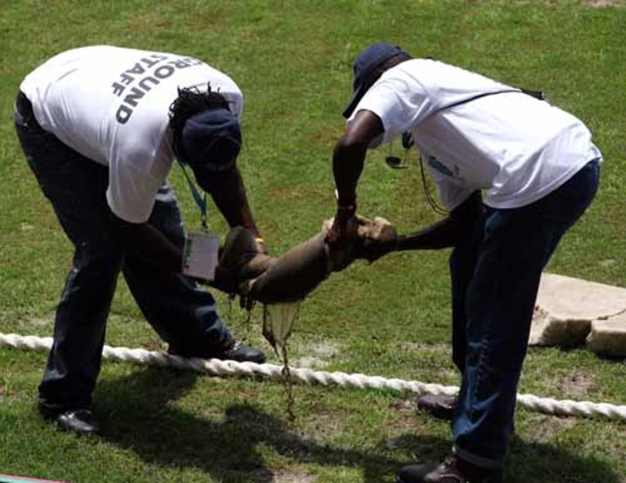 Two members of the groundstaff wring out water from the outfield, Australia v Bangladesh, Super Eights, Antigua, March 31, 2007
