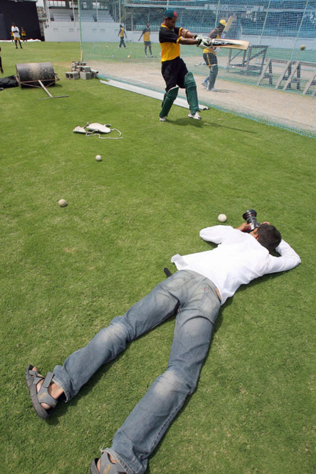 A photographer takes unusual steps to secure a picture of Habibul Bashar, Antigua, April 1, 2007