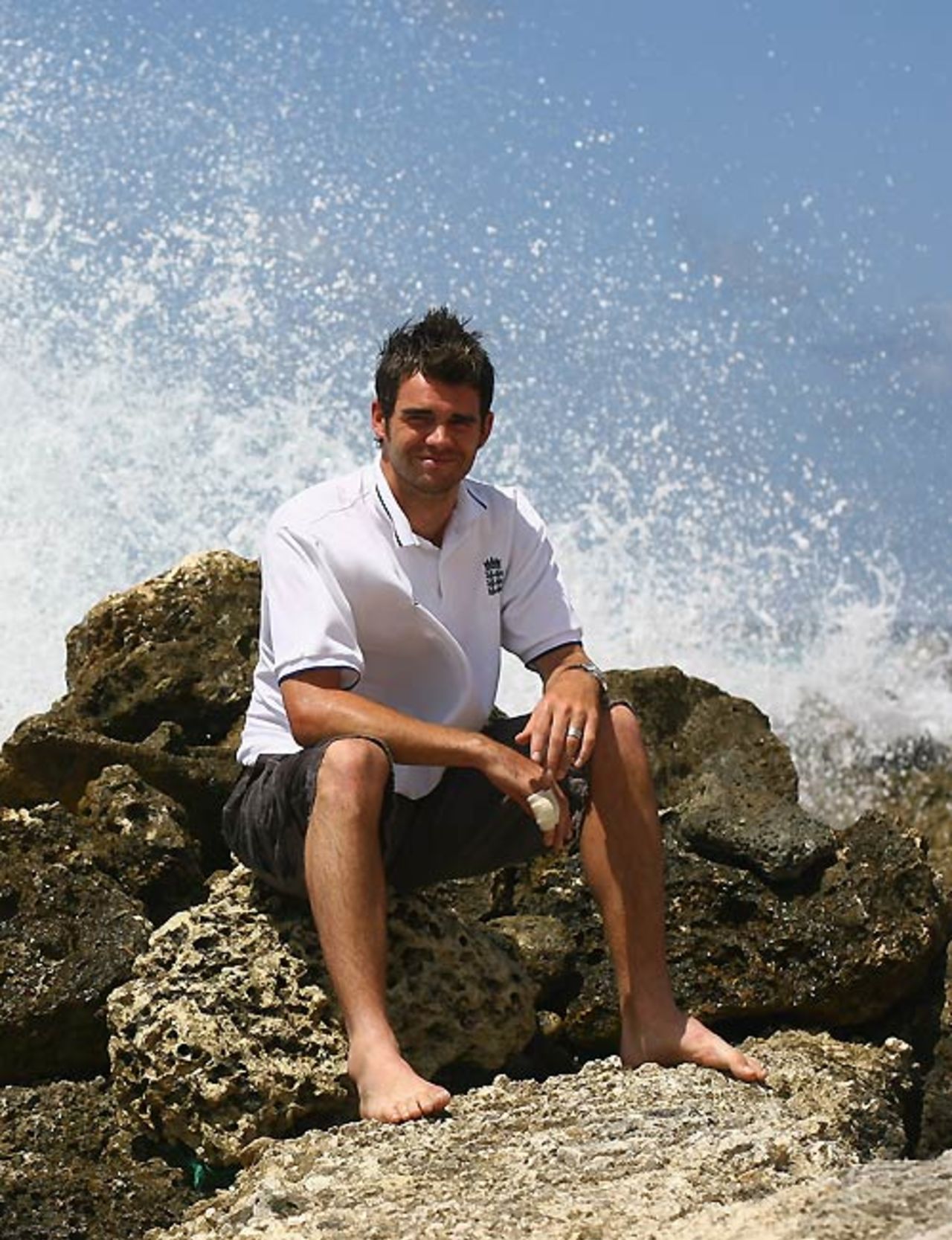 James Anderson sits amongst the rocks and waves outside the Hilton hotel, Barbados, April 12, 2007