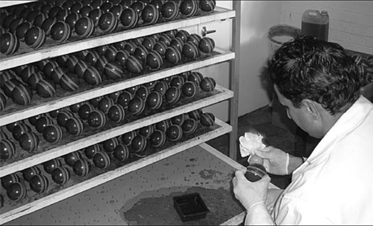 Javed Iqbal, a production assistant at the Dukes factory in London, applies the finish to a ball. 2006