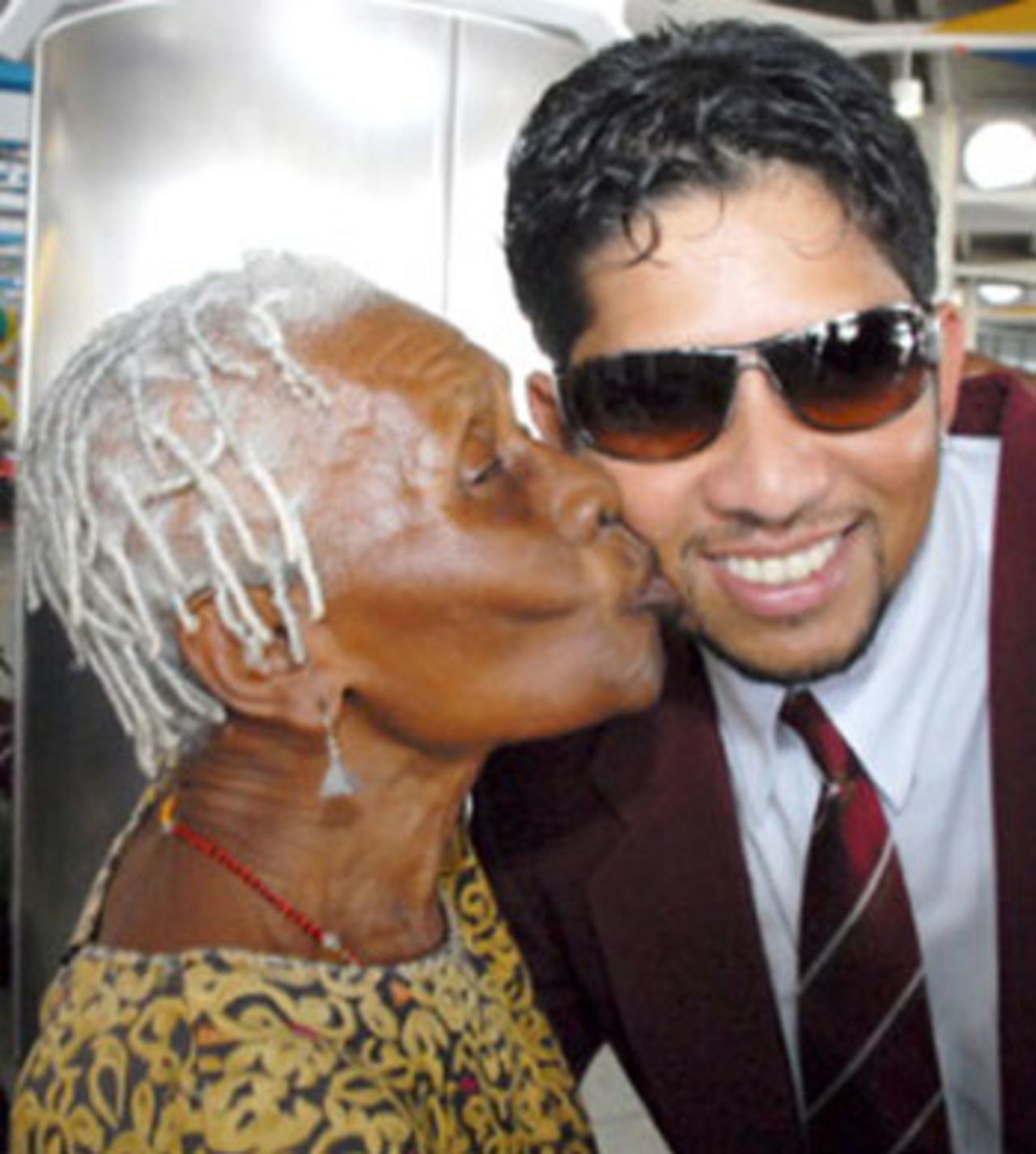 A well-wisher kisses Ramnaresh Sarwan as West Indies set off for England, Barbados, May 8, 2007