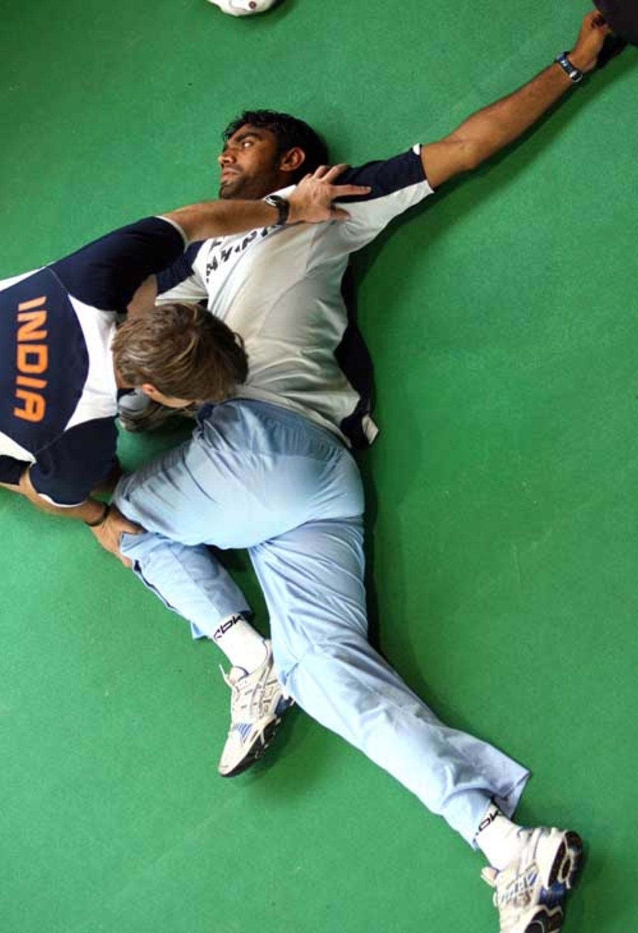 Munaf Patel does some stretches with the help of John Gloster, Chittagong, May 14, 2007
