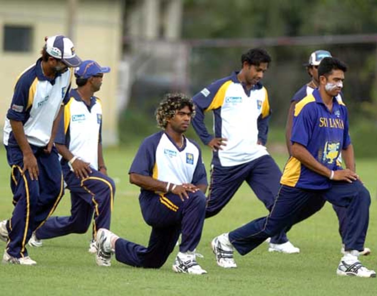 Sri Lankan cricketers warm up during a practice session ahead of their departure to Abu Dhabi, at the Nondescript Cricket Club in Colombo, May 14, 2007